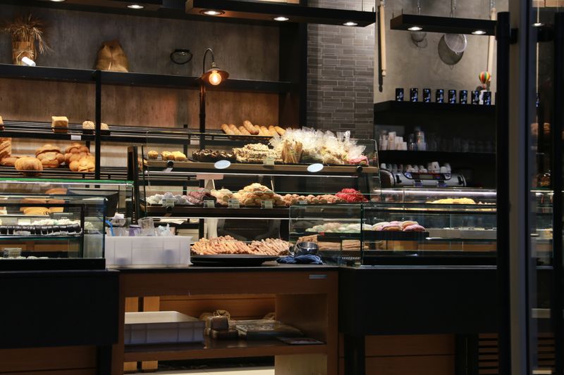 Tatte bakery interior with warm lighting and artisan pastries